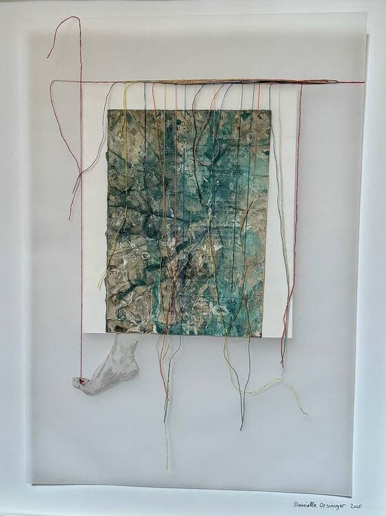 Collage in green and gold tones with hanging coloured threads; below, a foot suspended from a red thread.
