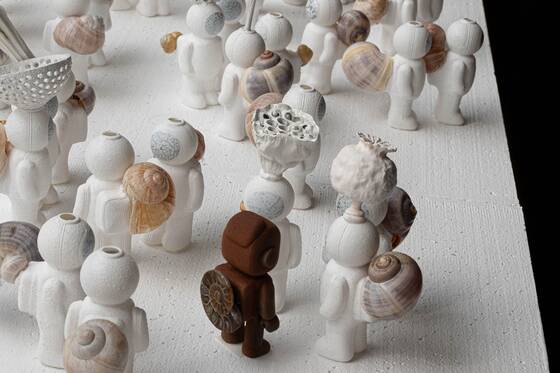 Many white UStronauts with snail shells, with a rust-brown RAWbot among them.